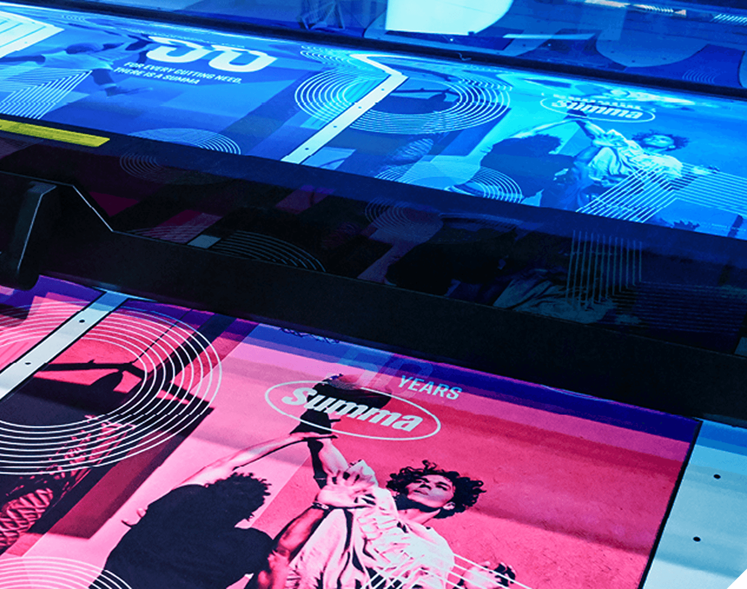 Printing process with vibrant posters featuring dancers and dynamic circular patterns in blue and pink hues.