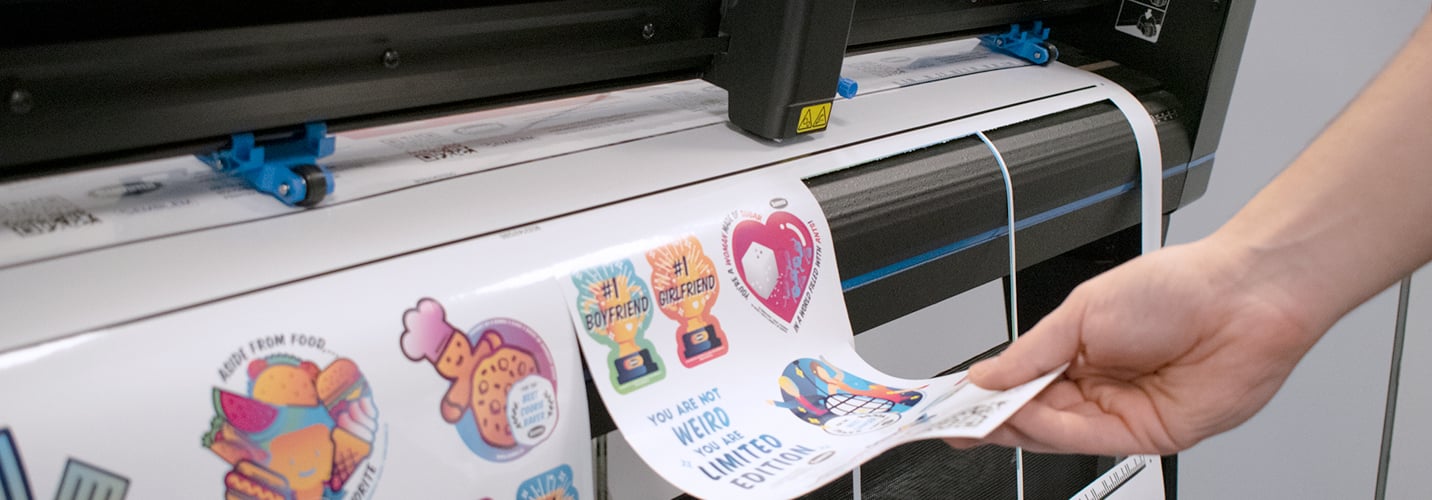 A Summa S One roll cutter is using its drag head to cut colourful stickers.